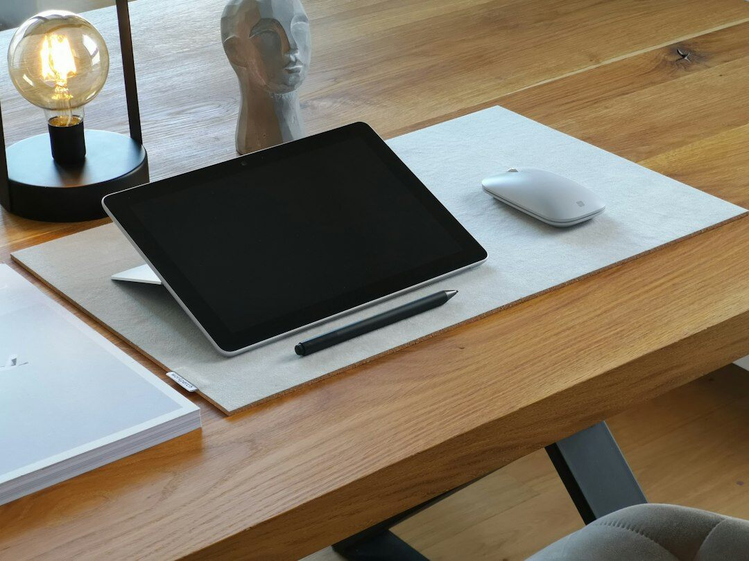 Desk with a tablet, notes and presentation slides mockup