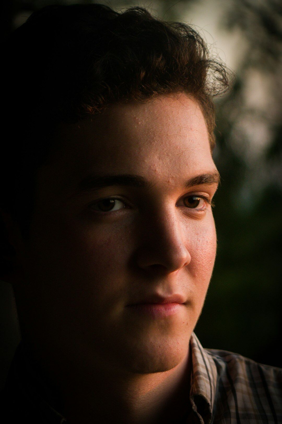 Studio headshot of a young man in a shirt